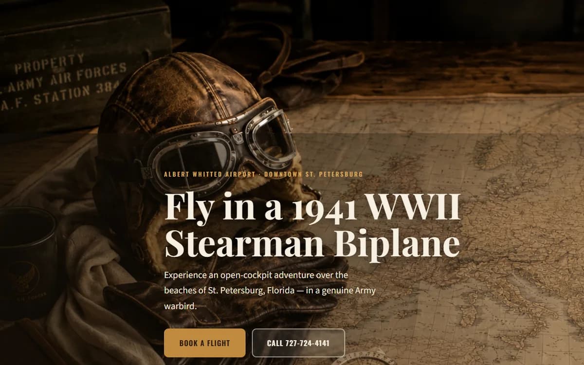 The Flying Adventure homepage — a vintage leather flying helmet and goggles resting on an old map, headline 'Fly in a 1941 WWII Stearman Biplane'.